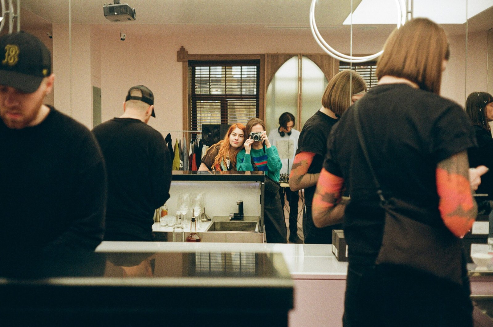 a group of people standing in a kitchen