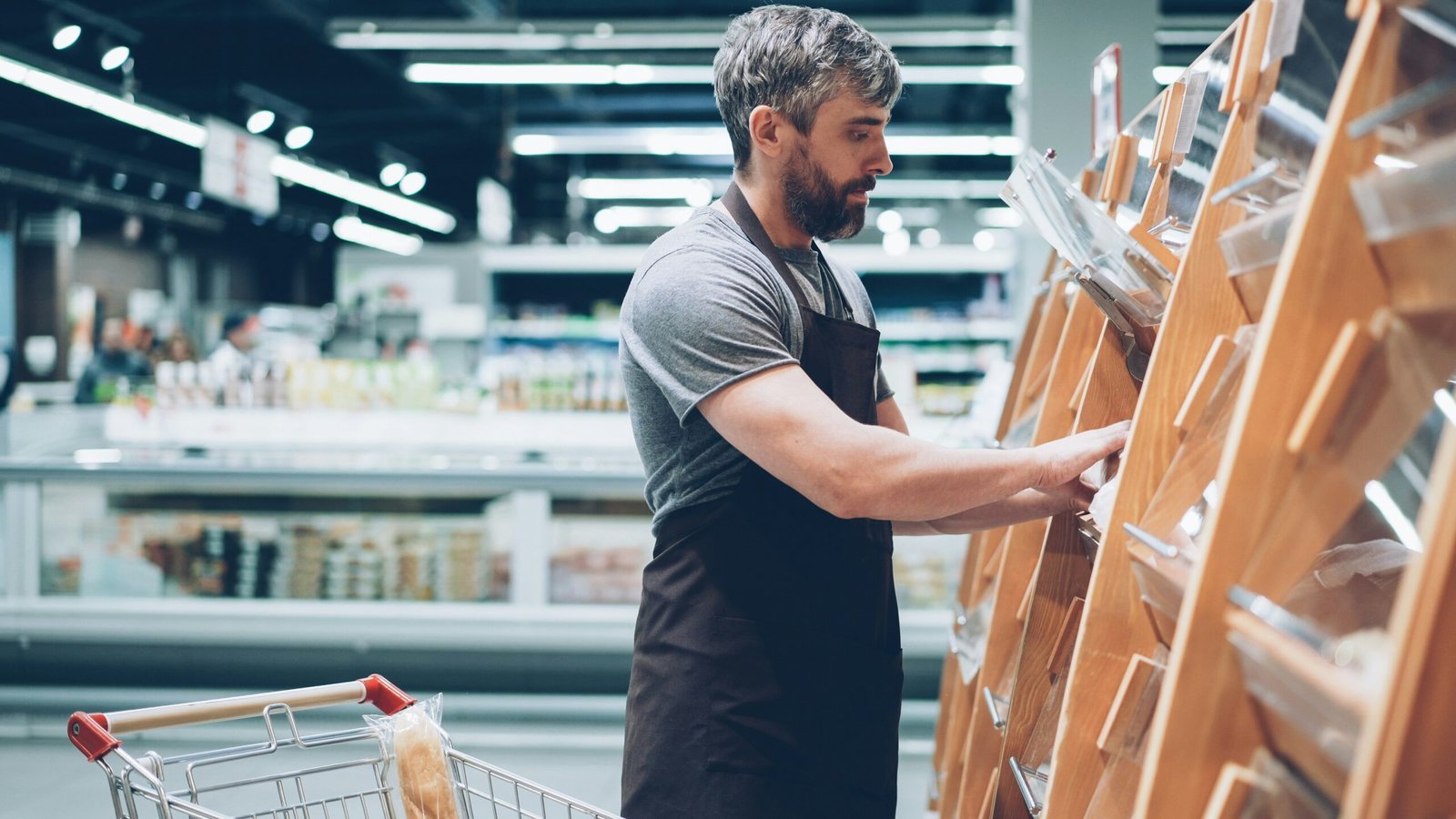 A man sorts items in a grocery store.