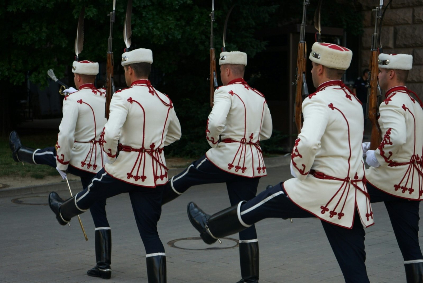 A group of men in uniform marching down a street