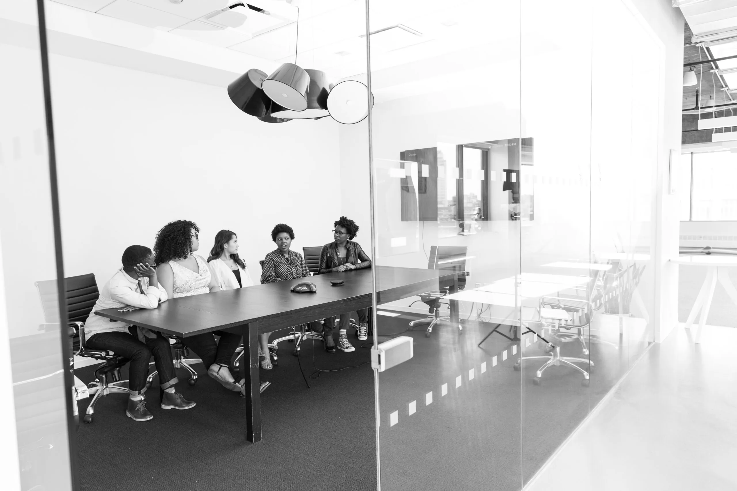 grayscale photo of people in room
