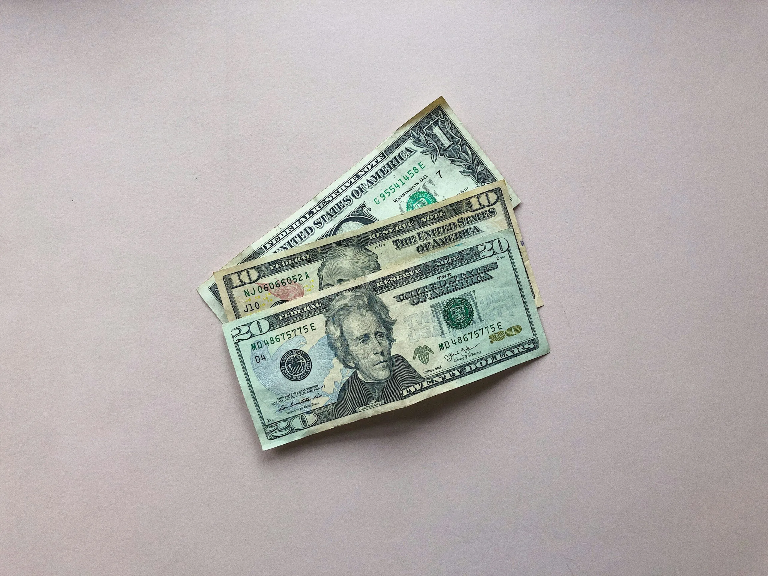 three assorted-denomination U.S. dollar banknotes