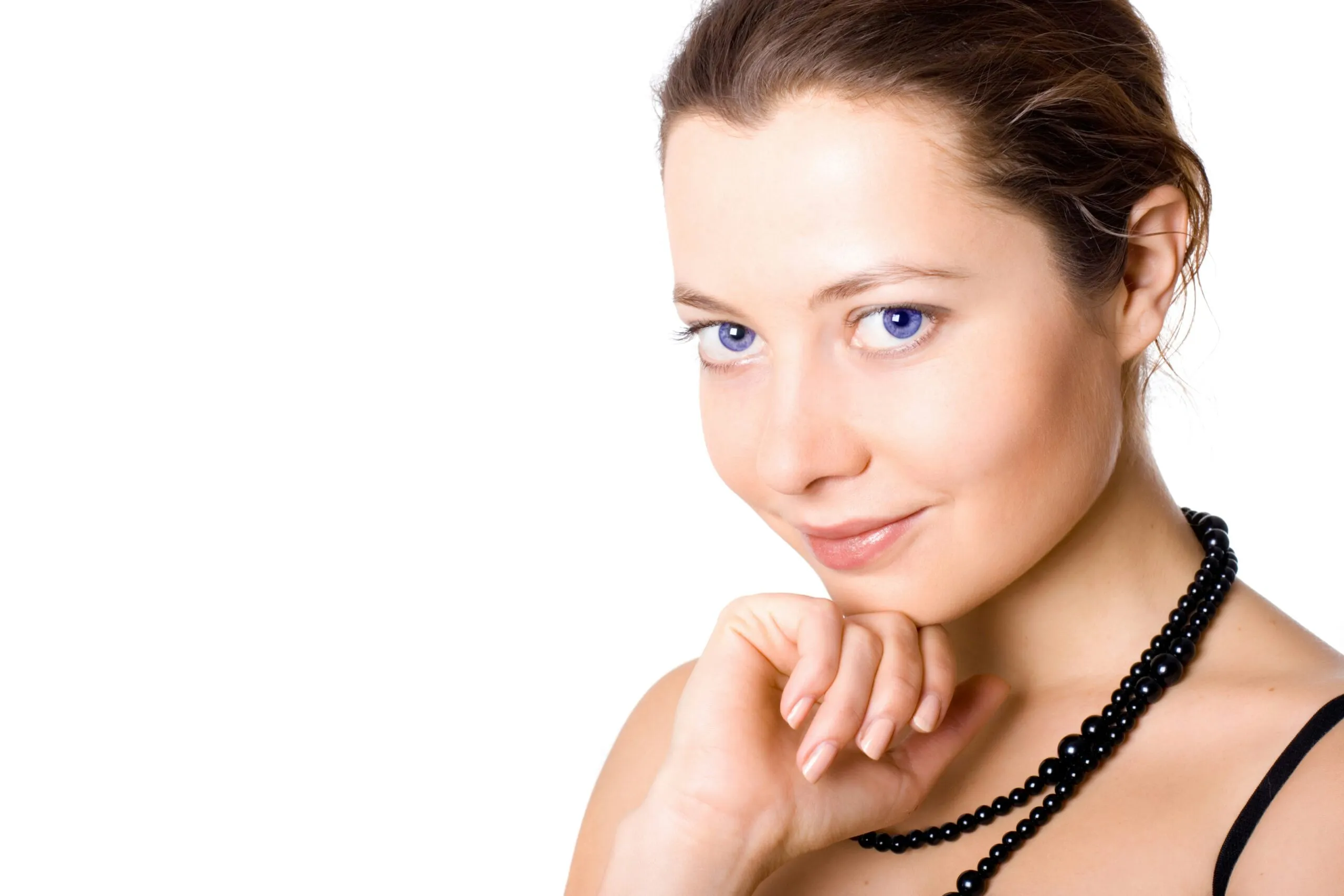 A woman with a necklace on her neck posing for a picture