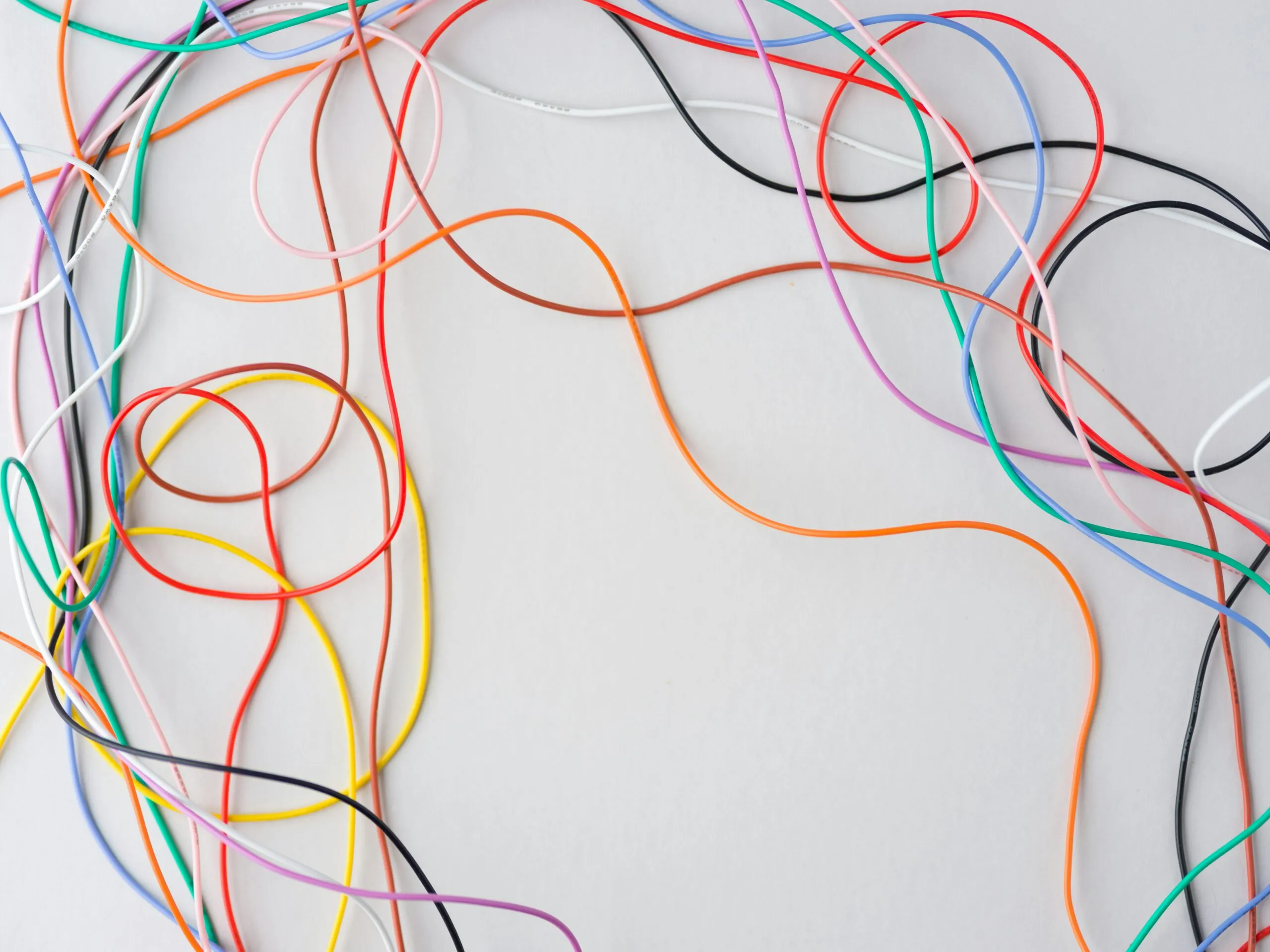 Colorful wires tangled on a white background