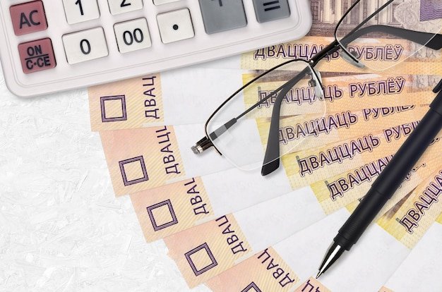 20 Belorussian rubles bills fan and calculator with glasses and pen.