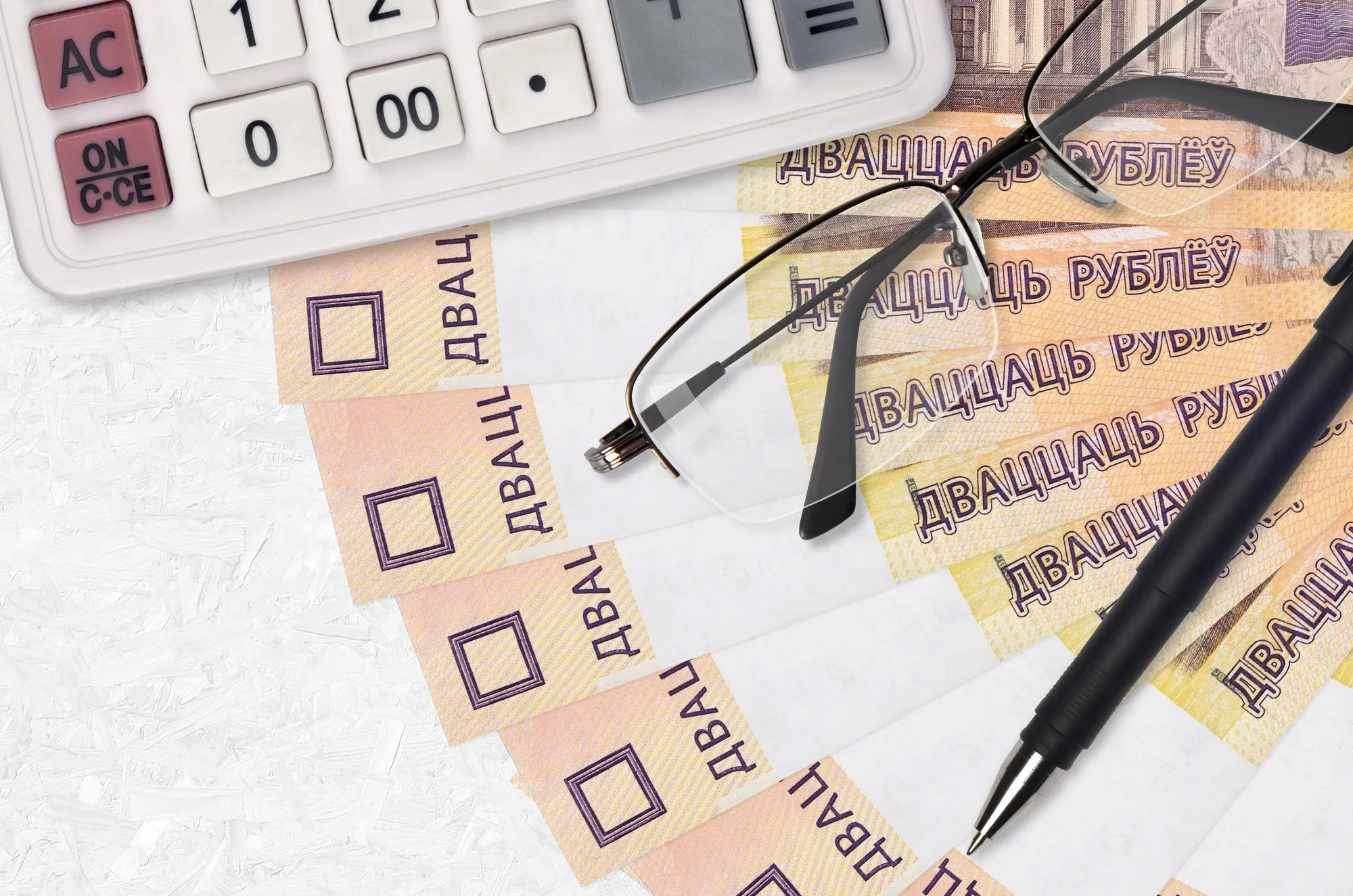 20 Belorussian rubles bills fan and calculator with glasses and pen.