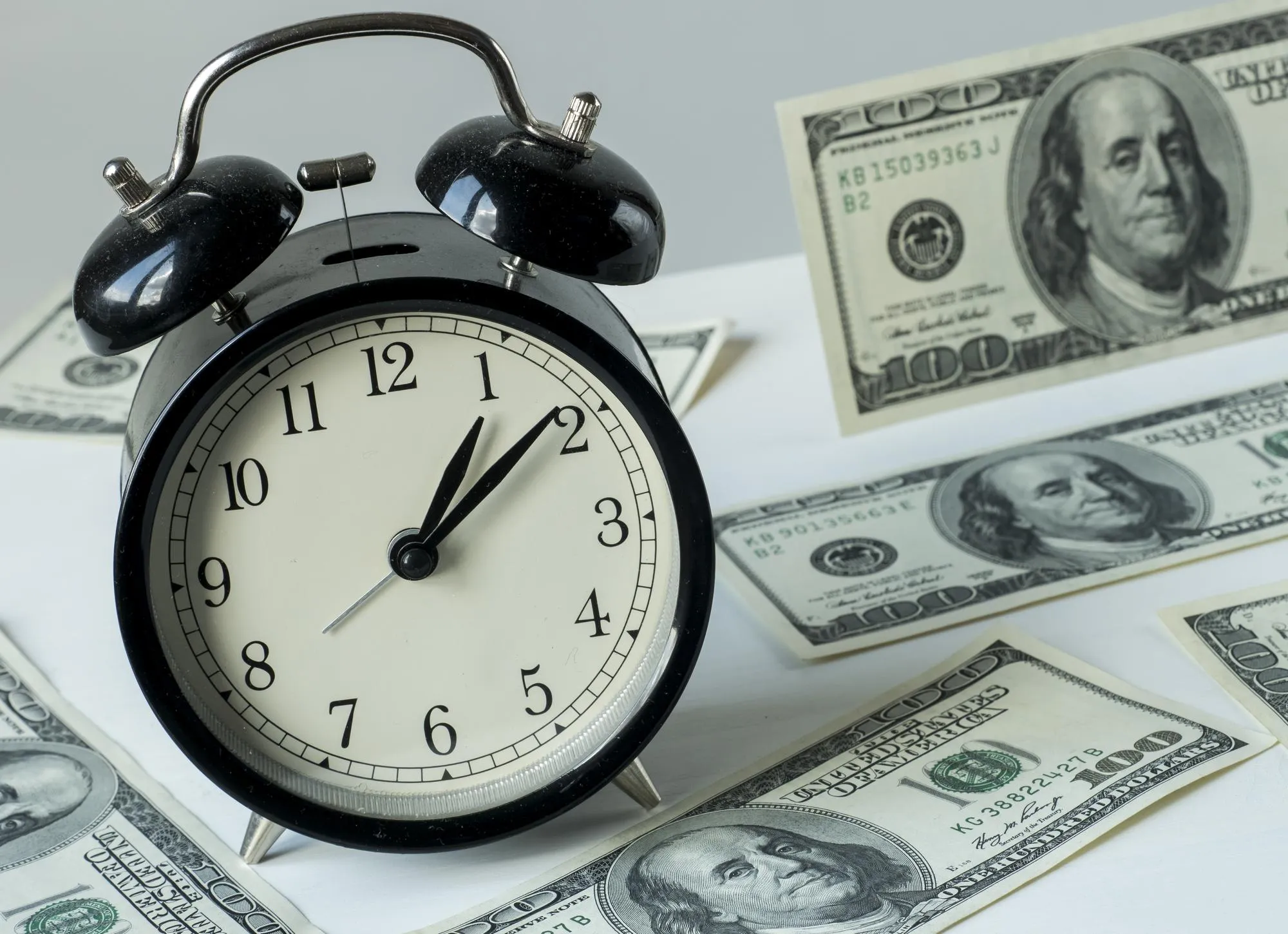 American dollars and alarm clock time is money concept