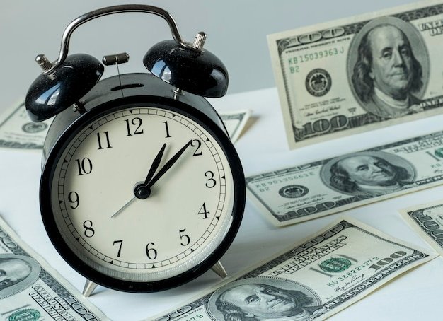 American dollars and alarm clock time is money concept