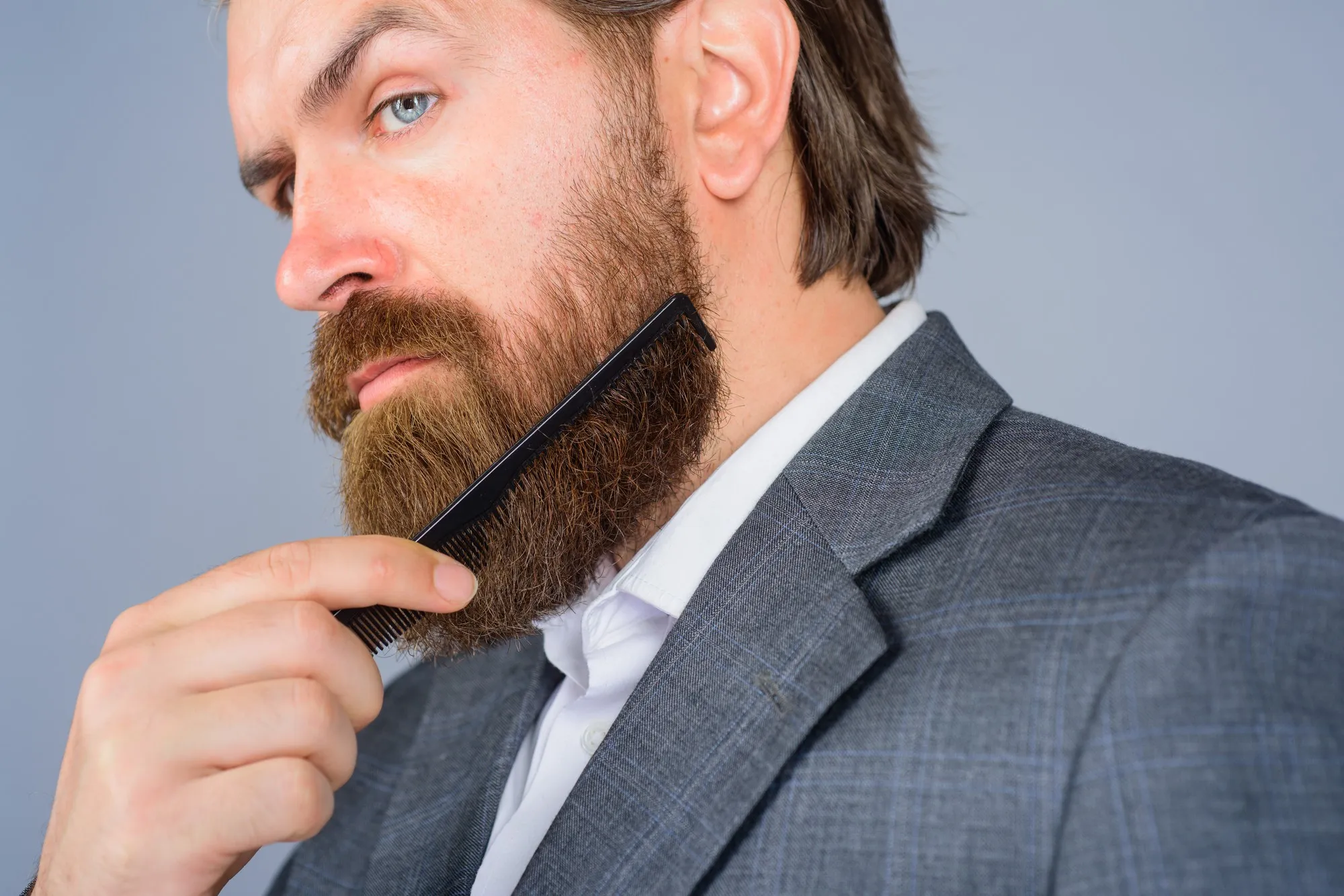 Barbershop advertising professional beard care hairdresser bearded man with comb barbershop bearded