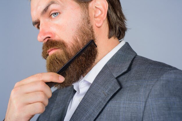 Barbershop advertising professional beard care hairdresser bearded man with comb barbershop bearded