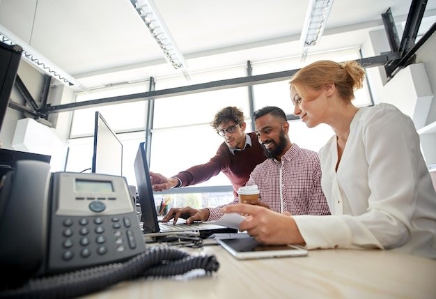 business, startup and people concept - international creative team laptop computer and coffee in office