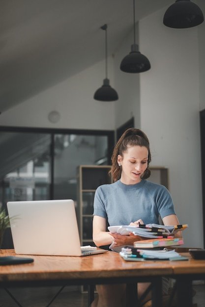 Business woman manager accounting analyst checking bills analyzing sales statistics management taxes financial data documents or marketing report papers working in office using