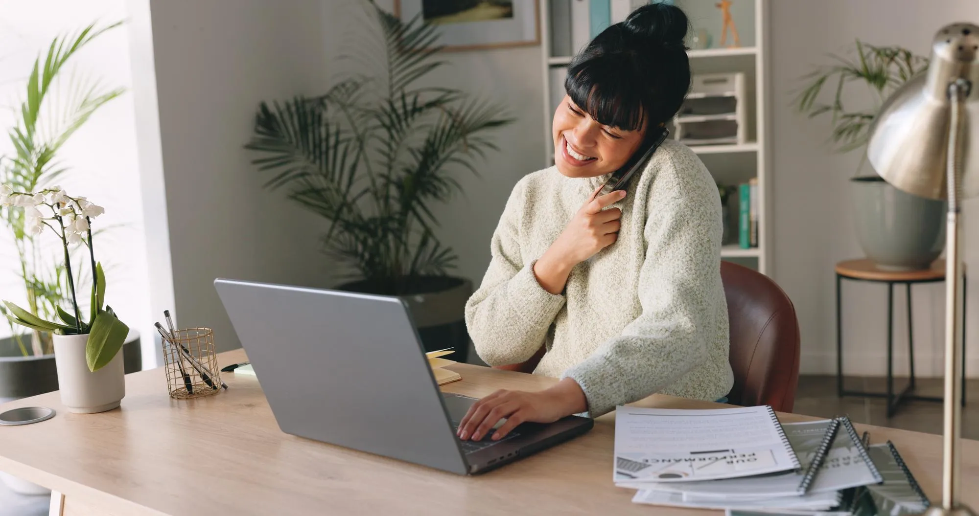 Business woman phone call and laptop in home office for customer networking sales consulting or digital marketing strategy Smile happy or remote lockdown worker with paper documents or technology