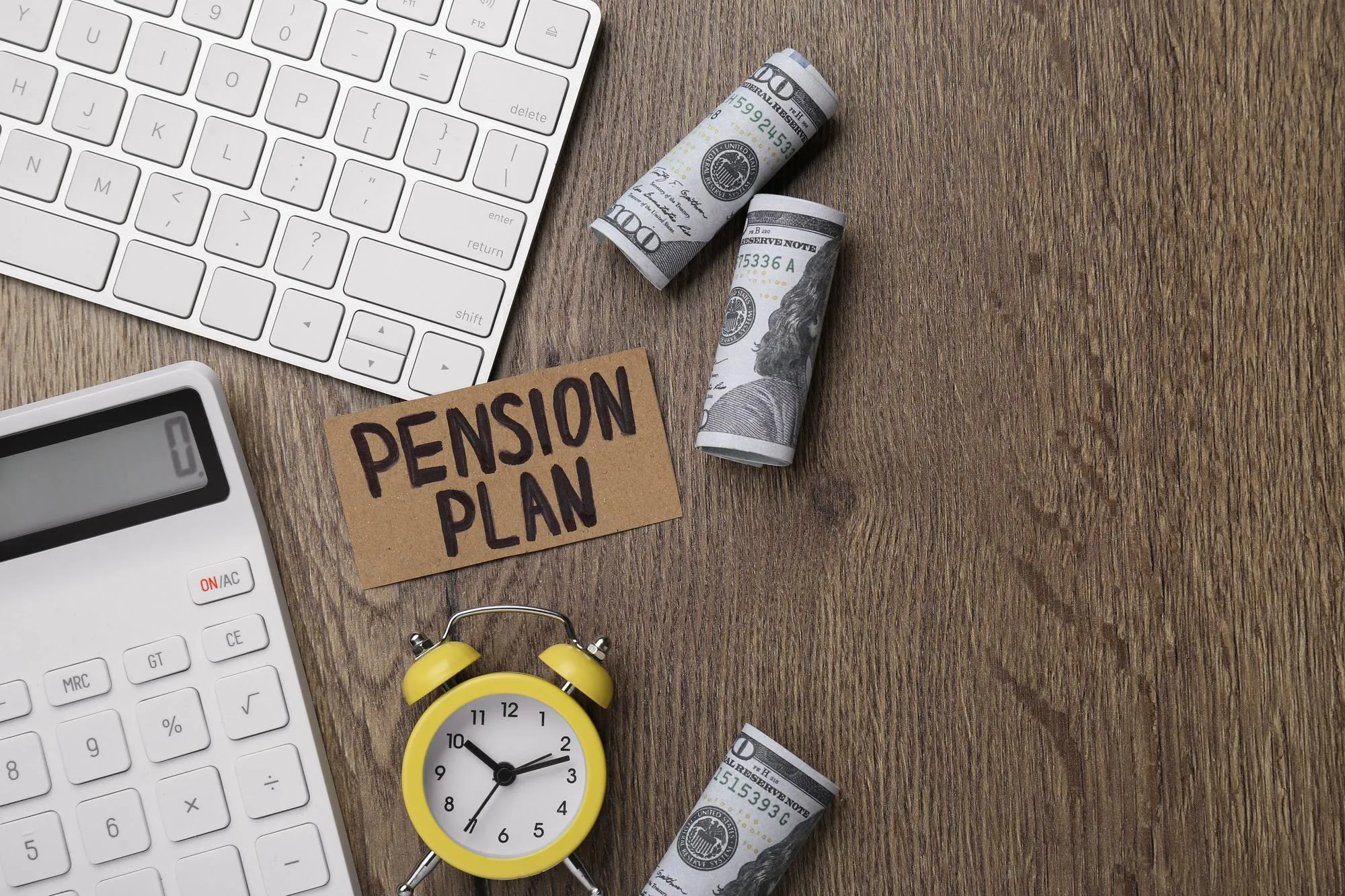 Card with words Pension Plan banknotes calculator and alarm clock on wooden office table flat lay Space for text