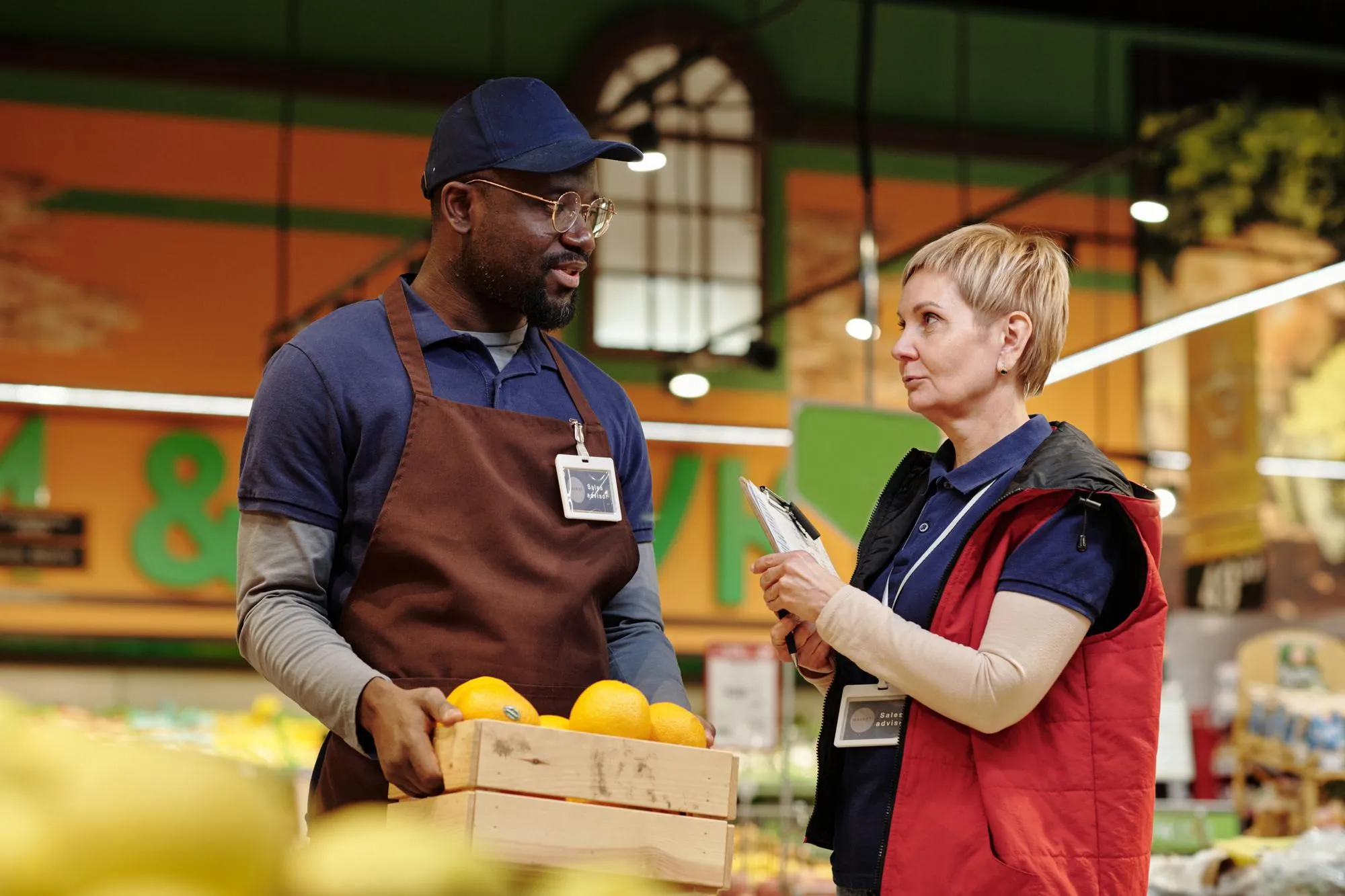 Confident mature sales advisor listening to her colleague