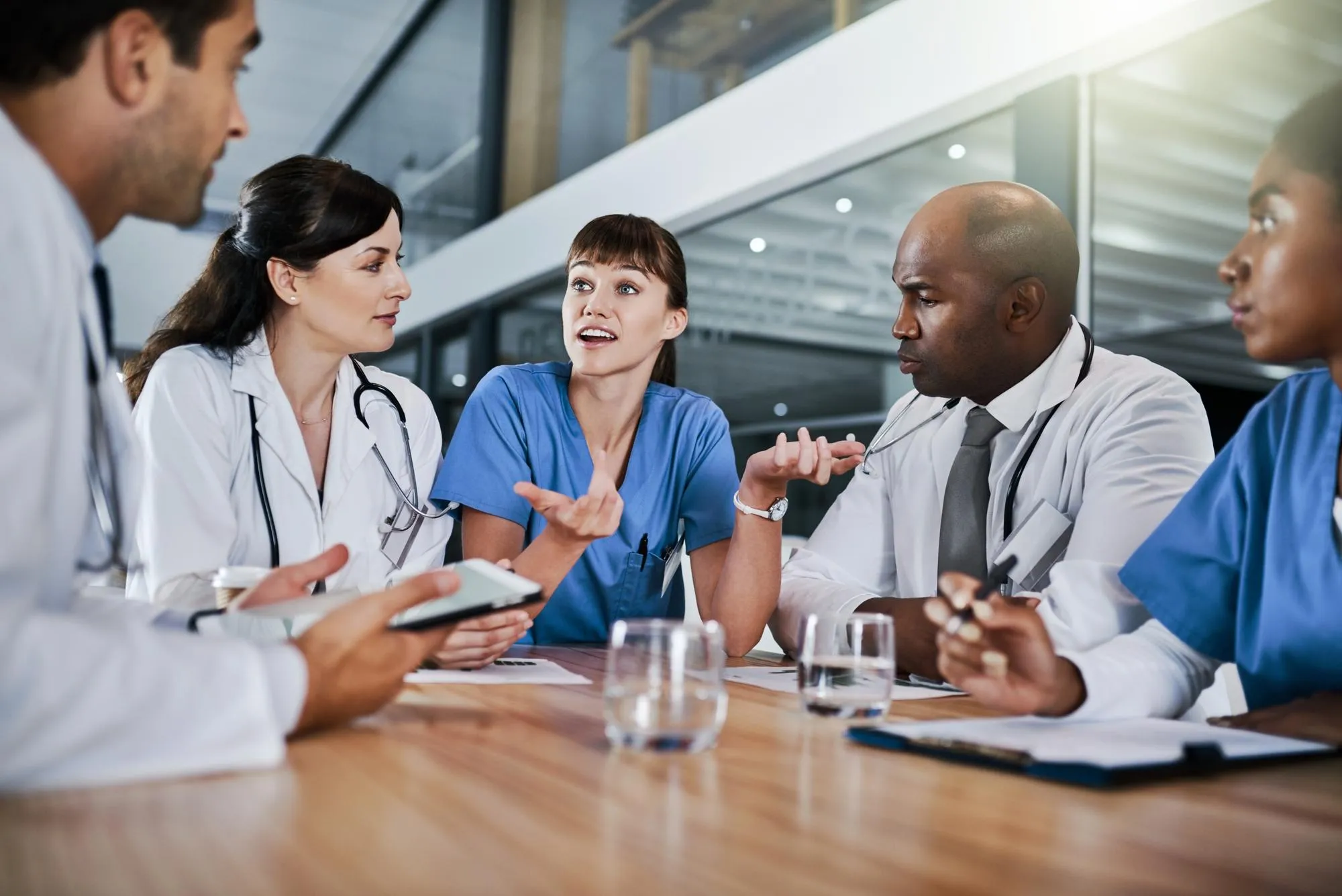 Conversation meeting and team of doctors in hospital with planning for medical treatment in collaboration Nurses discussion and group of healthcare workers with research for surgery in clinic