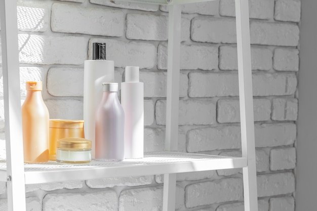 Cosmetic bottles against bathroom wall