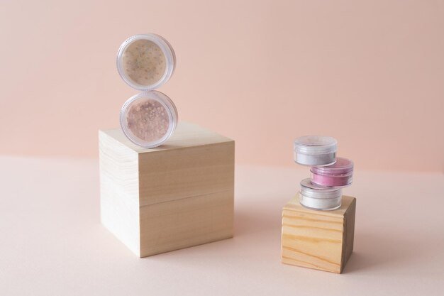 Cosmetic set of various shades compact face mineral powder on pastel background natural eco friendly
