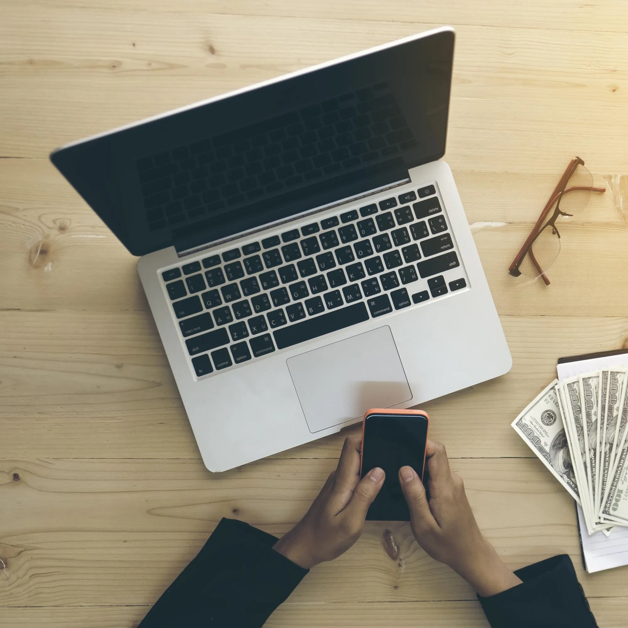Cropped image of business person working at desk in office