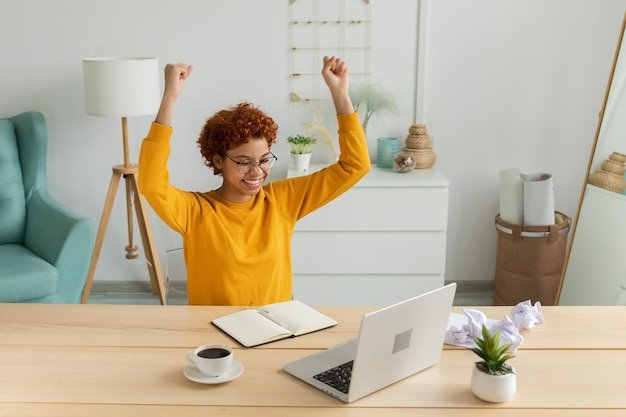 Excited happy african american woman euphoric winner girl student looking at laptop passed exam read