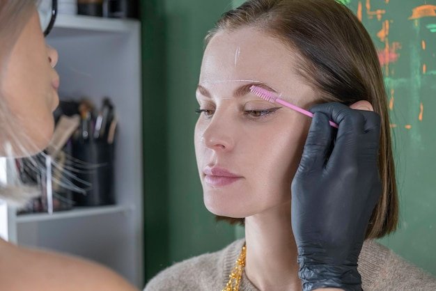 Eyebrow lamination procedure styling correction coloring and in beauty salon eye brow care treatment