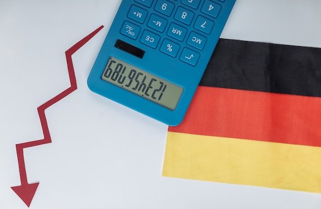 Germany flag with red Fall arrow and calculator. Fall graph going down. Economic recession, crisis