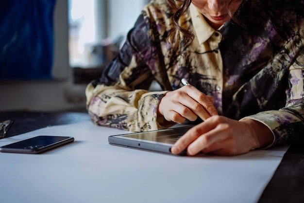A girl draws on a tablet