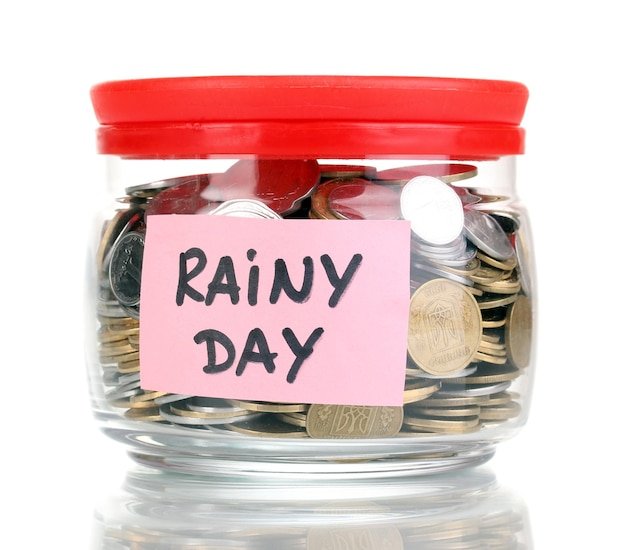 Glass bank for tips with money isolated on white