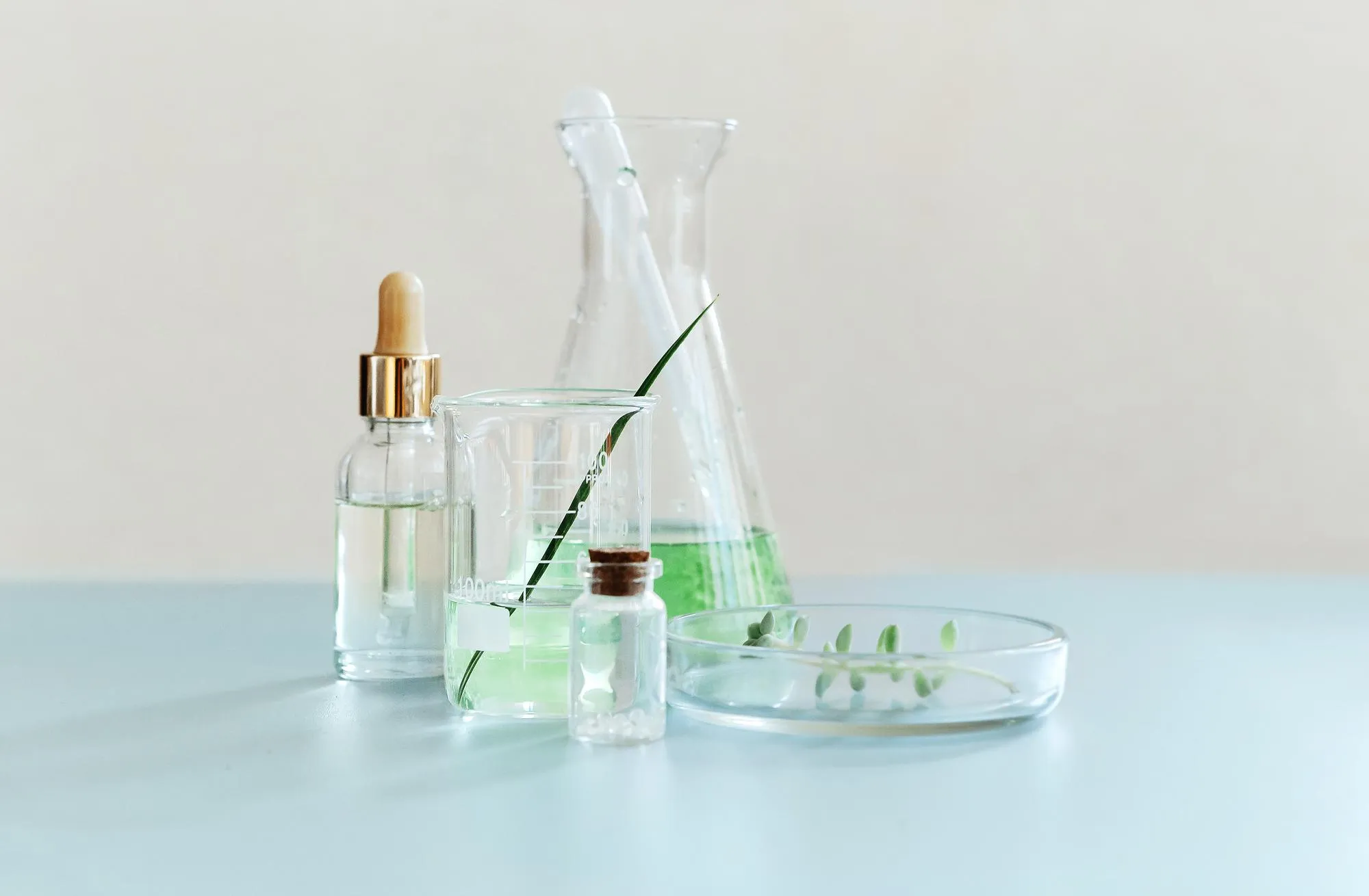 Glass bottle on table against white background