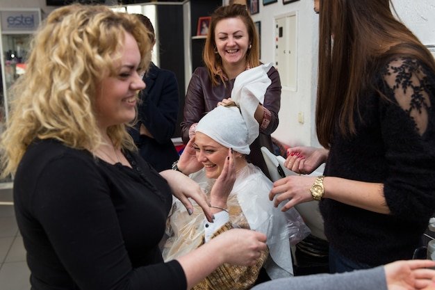 Grodno, Belarus - October 20, 2016: Participants of the seminar dye the hair of a model on advertising workshop of Keune brand in the beauty salon Kolibri.