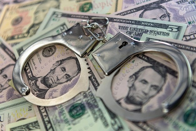 Handcuffs on money background dollar bills money cash corruption