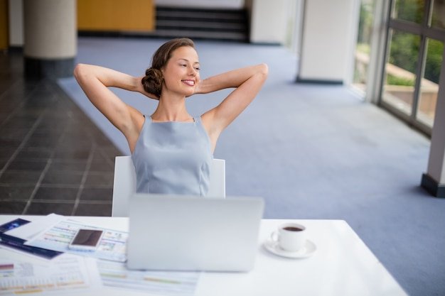 Happy businesswoman relaxing at desk