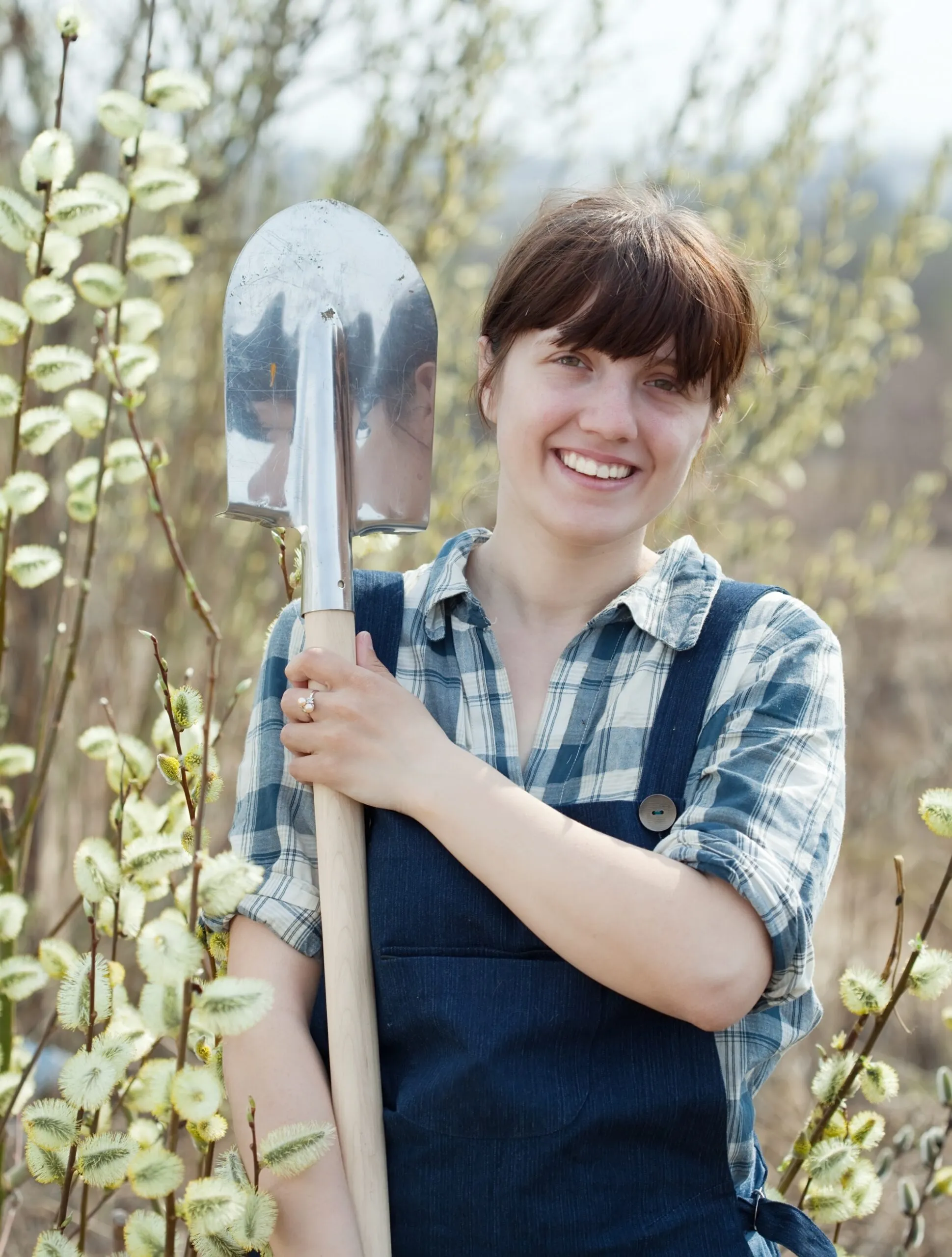 Happy woman with shovel