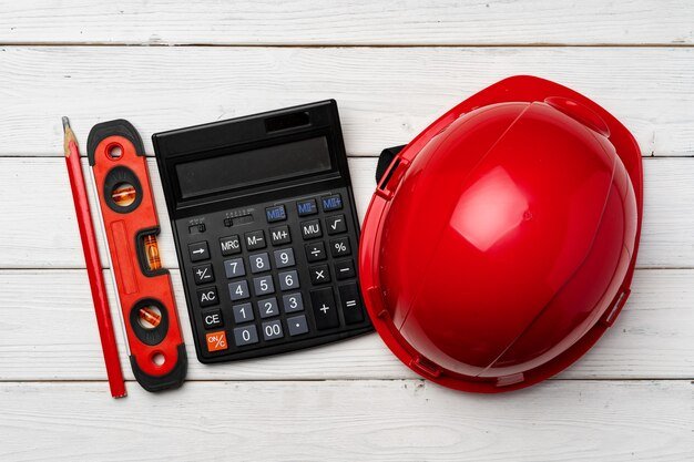Hardhat helmet and construction level top view, copy space