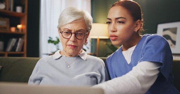 Healthcare laptop and old woman with nurse on sofa in retirement home for internet advice or checkup Assisted living computer and consulting with medical professional talking to senior patient