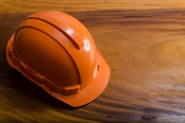 High angle view of orange hardhat on table