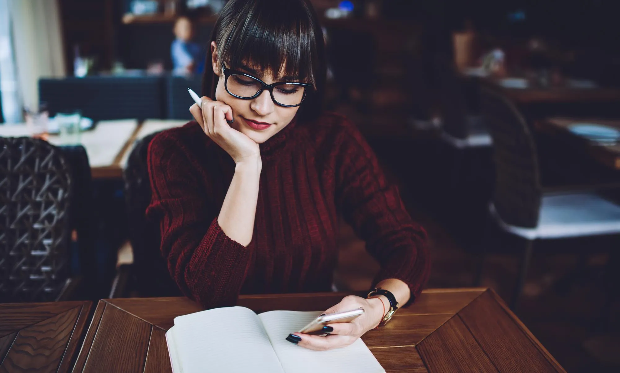hipster girl reading text message using new application for communicate on cellular phone