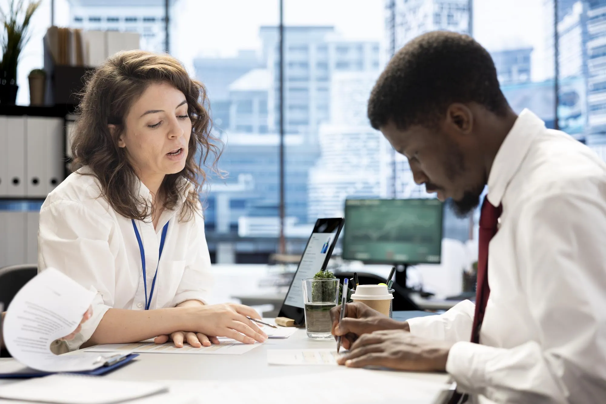 HR employee signing contract with applicant after job interview
