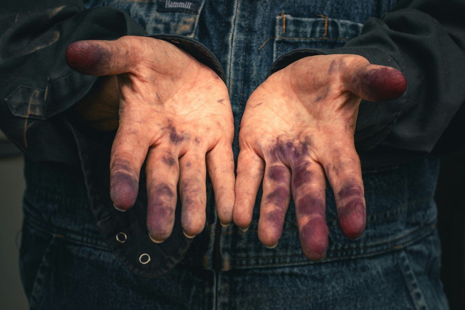 Hands covered in purple ink.