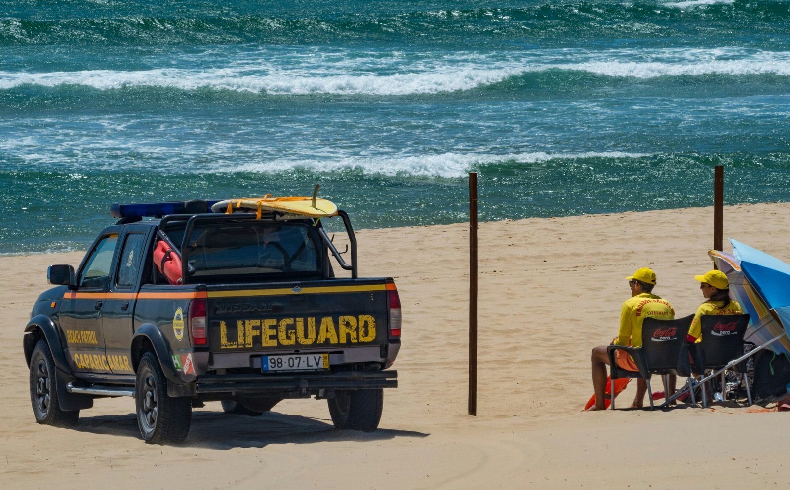 black pickup truck near body of water