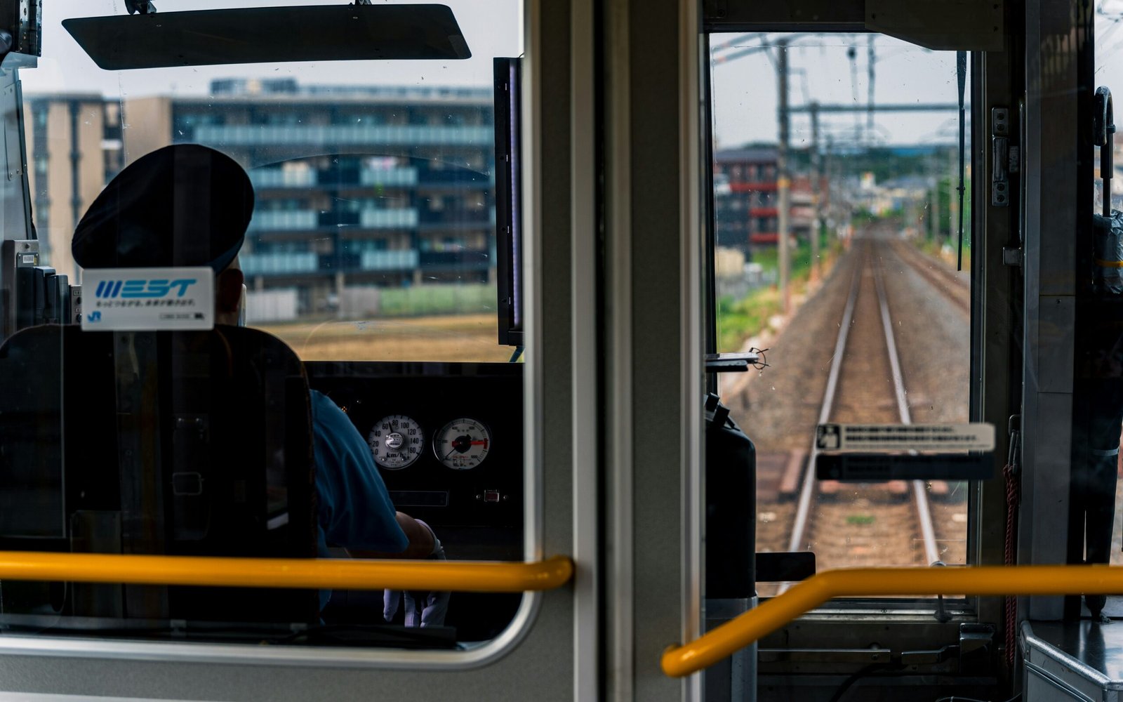 Train conductor in the cab looking at tracks