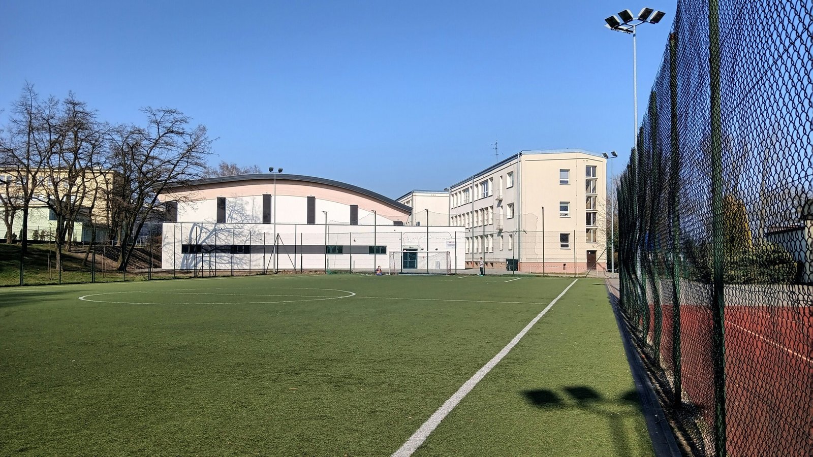 a soccer field with a building in the background