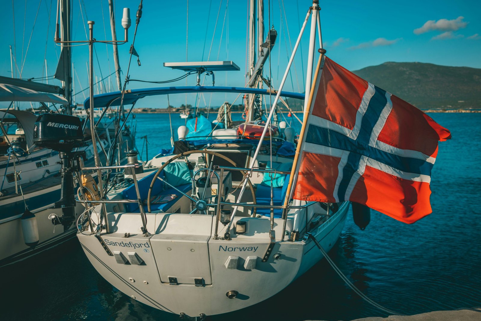 white and red sail boat on body of water during daytime