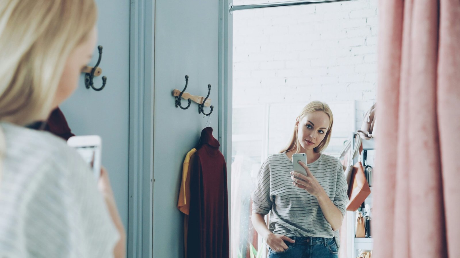 Woman takes a selfie in a dressing room.