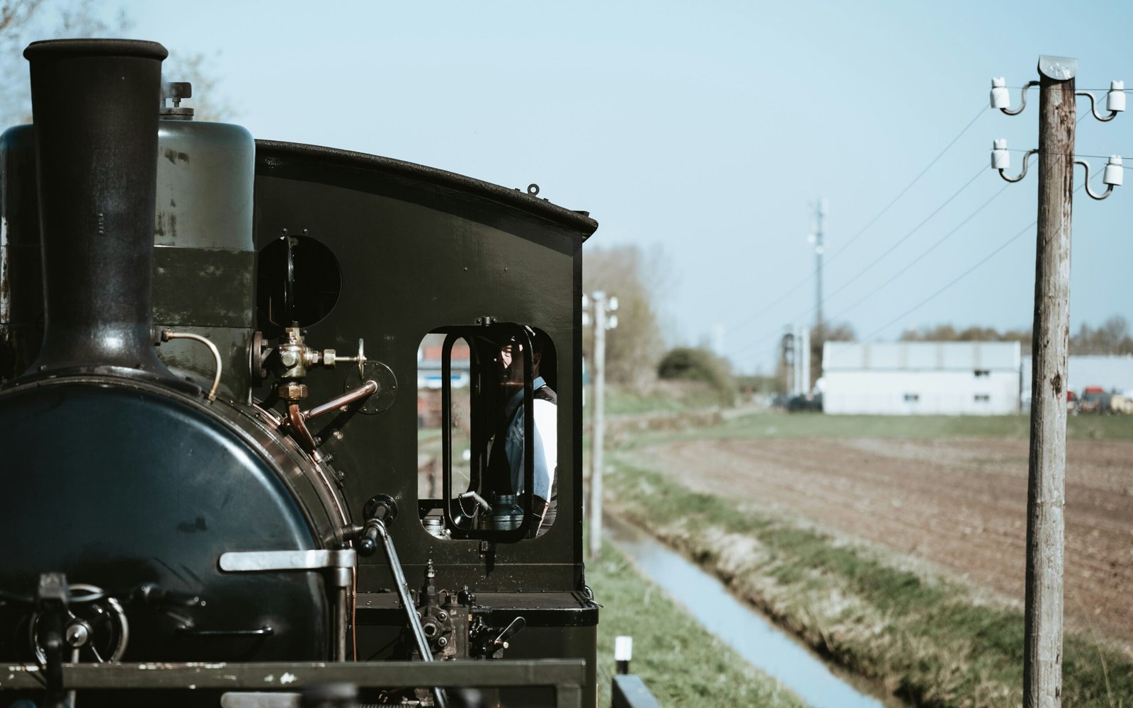 A vintage train moves along a track.