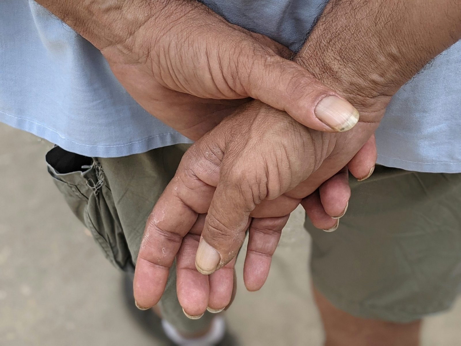 a close up of a person holding their hands together