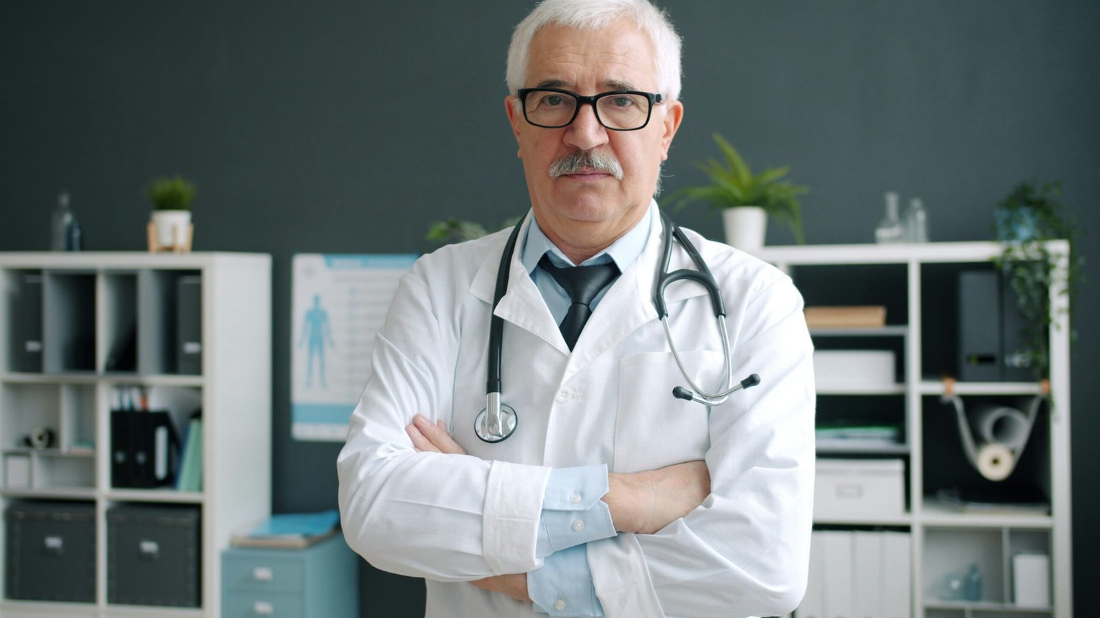 Elderly doctor with stethoscope in a clinic
