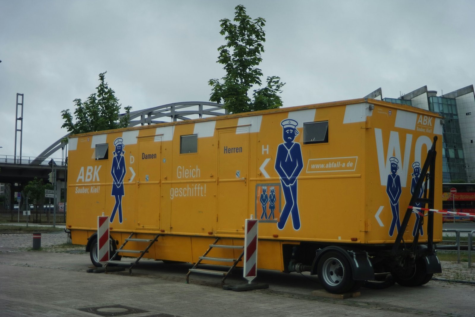 a yellow truck with a man painted on the side of it