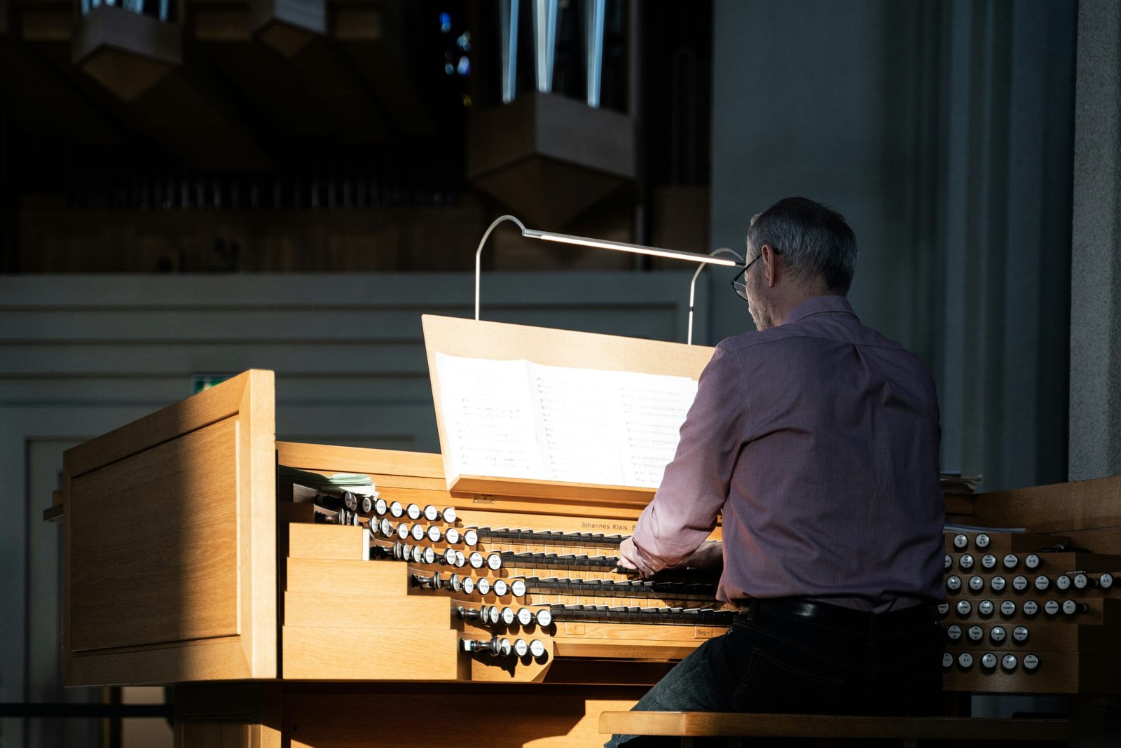 a man playing a pipe organ in a church