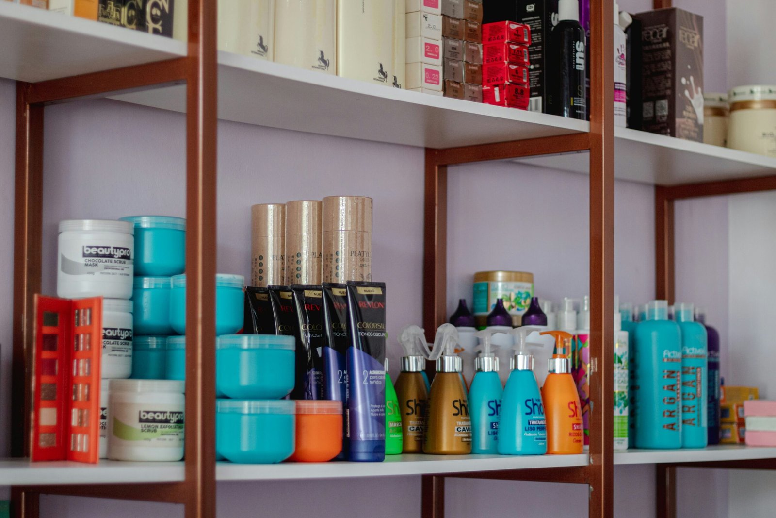 a shelf filled with lots of different types of hair products