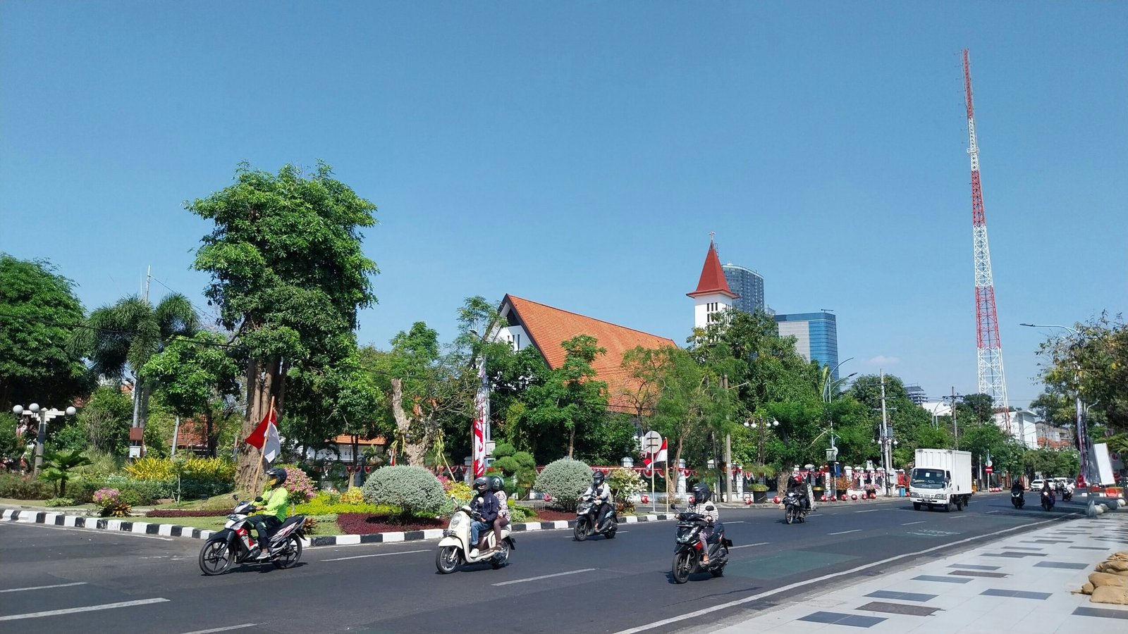 a group of people riding motorcycles down a street